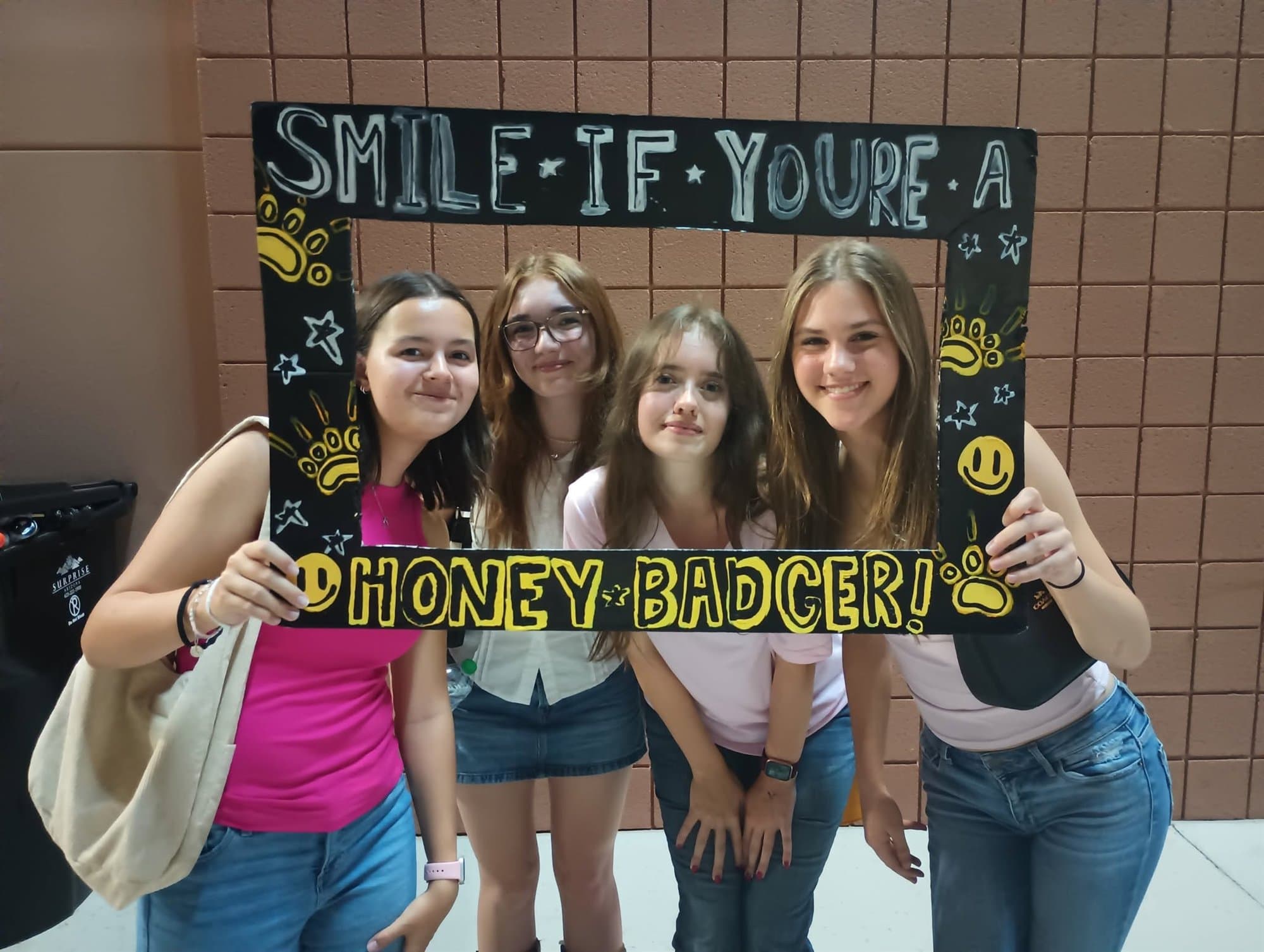 Highland Prep students posing with a Honey Badger photo frame