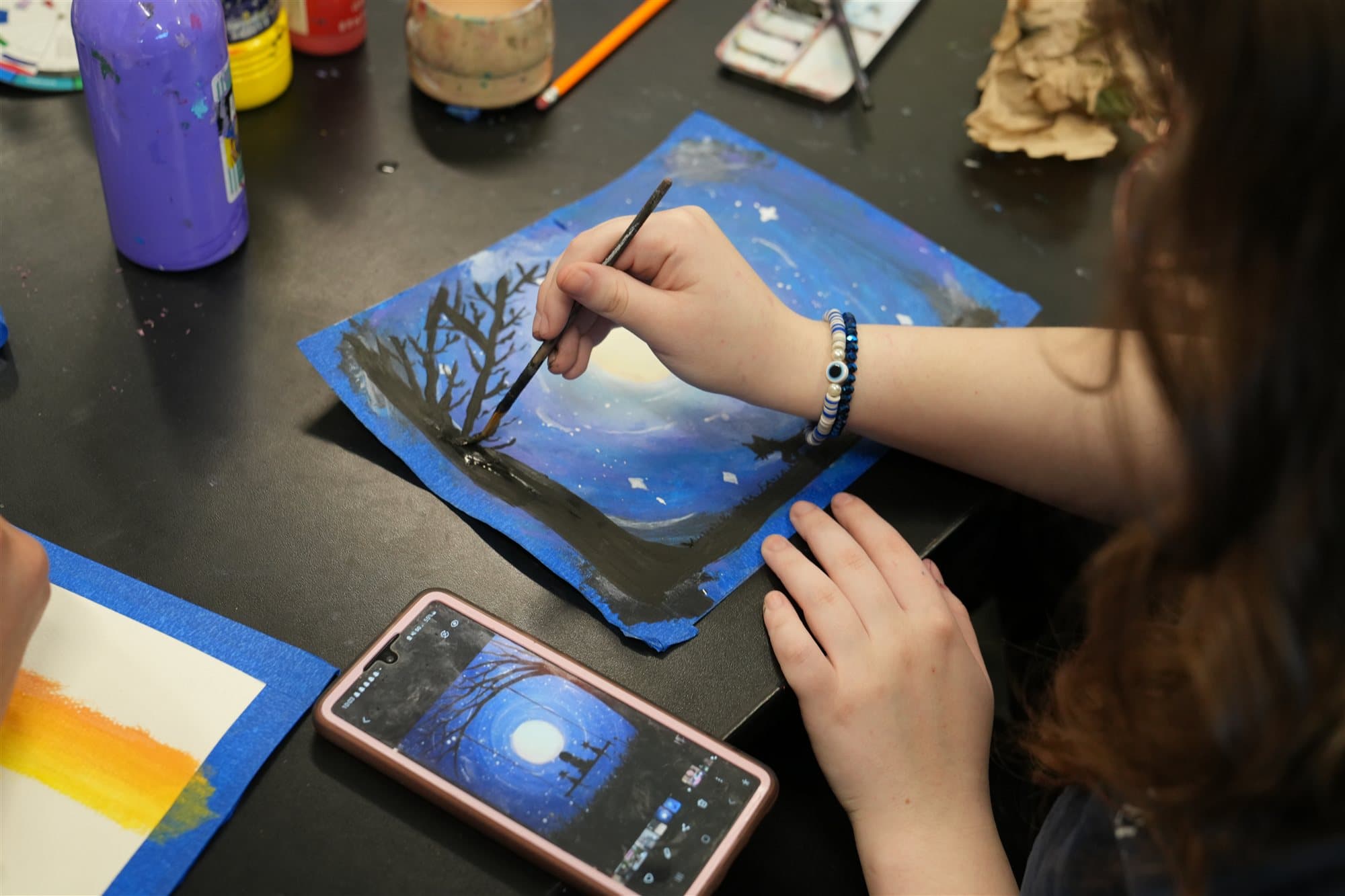 Highland Prep student painting in art class